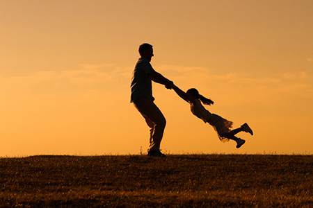 Father and daughter enjoy spending time together outdoor.