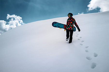 Girl snowboarder enjoys winter sport