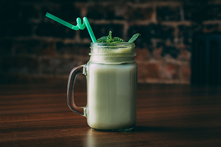 A jar of fresh tasty buttermilk on a wooden table