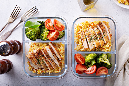 Healthy meal prep containers with chicken, rice and vegetables