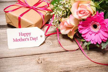 gift box and flowers on wood counter