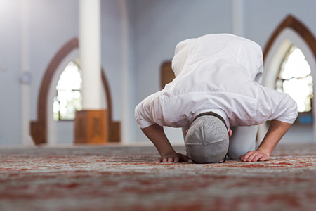 Religious muslim man praying inside the mosque