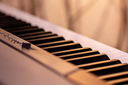 Piano keys on a beautiful colored background - Close up.