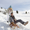 Young couple sledding