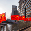 Row of Chinese flags on Huangpu river promenade, Shanghai, China