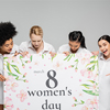 amazed woman pointing at huge womens day greeting card