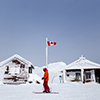 Snow covered mountain hut with a Canadian flag on Whistler Mountain, BC.