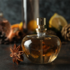 Composition with bottle of perfume, close up