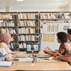 Group of foreign students studying while sitting in the library