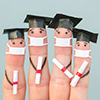 Fingers art of students in medical mask from COVID-2019. Graduates holding their diploma after gradu