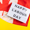 Labor Day greetings text on lightbox on yellow background with Canadian flag