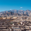 Landscape and building in city with mountains and blue sky background