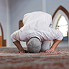 Religious muslim man praying inside the mosque