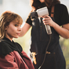 hairdresser combing a young woman's hair