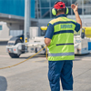 Supervisor standing in front of a pushback tug at the airport