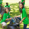A vibrant voluntary community clean-up day brings together enthusiastic volunteers clad in green shi