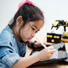 A primary school girl focuses on learning using tablet