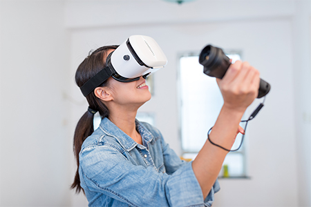 Woman play game with VR device 