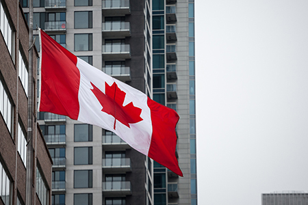 Canadian flag in front of a residential condo appartment building in Montreal, Quebec, Canada.