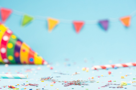 Birthday party background with colorful confetti and streamers