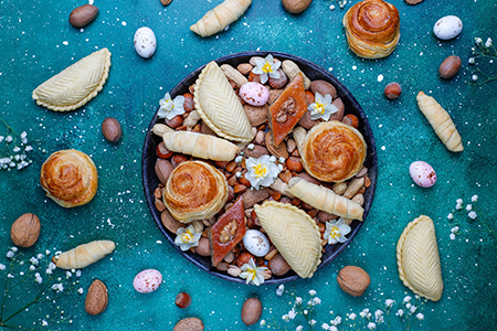 Traditional Azerbaijan holiday Novruz cookies baklavas and shakarburas on black tray plate on dark b