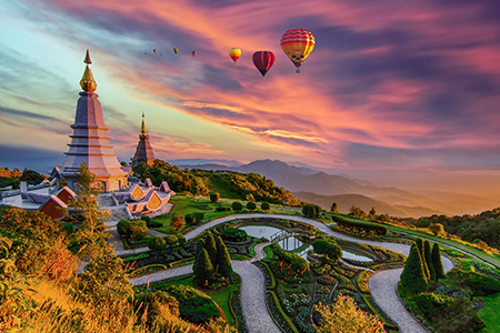 Colorful hot air balloons flying over two pagoda in Doi Inthanon Mountain in Chiang Mai, Thailand, H