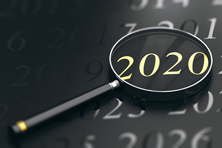 3D illustration of year 2020 written in golden letters and a magnifying glass over black background