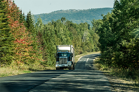 Semi truck on Highway in deep forest in Canada ontario quebec