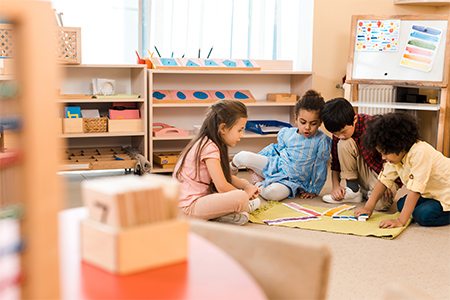 group of children playing game on floor in school