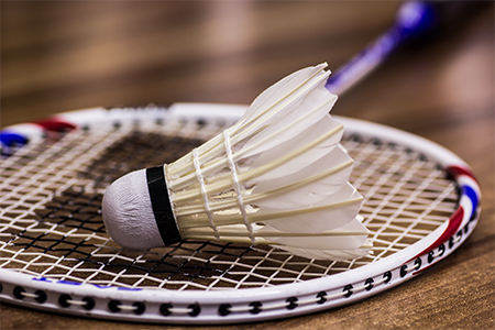 A closeup selective focus shot of badminton on a white surface