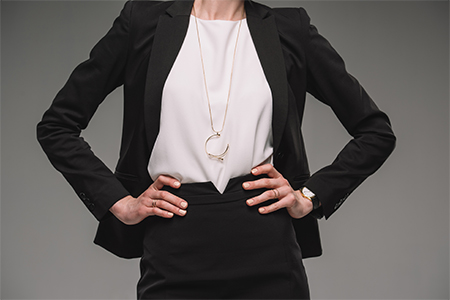 businesswoman standing with hands, isolated on grey background