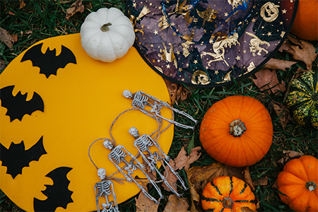 Halloween flatlay with skeletons and pumpkins