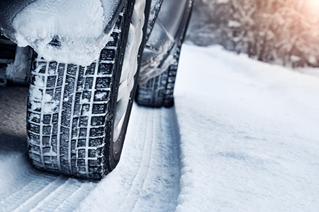 close up of car tires in snow