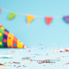 Birthday party background with colorful confetti and streamers