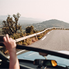 Long and winding asphalt road leading through hills