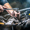 Auto mechanic working on car engine in mechanics garage. Repair service. authentic close-up shot