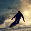 Snowboarder slides down the snowy hill