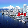 Canadian flag in front of view of False Creek and the Burrard street bridge in Vancouver, Canada.