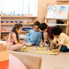 group of children playing game on floor in school