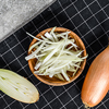 Yellow raw shallot onions, sliced and halved, Gray background. Top view.