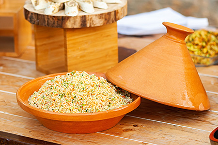 Vegetable Tajine with cous cous on wooden table