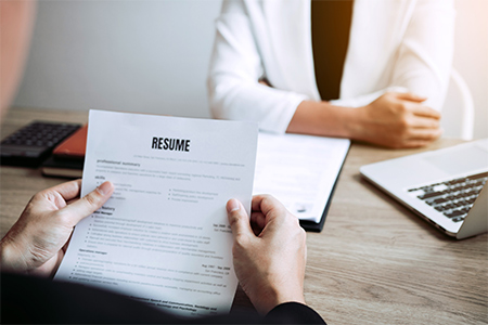 Job applicants are holding a resume document in the job interview room, job interview concept