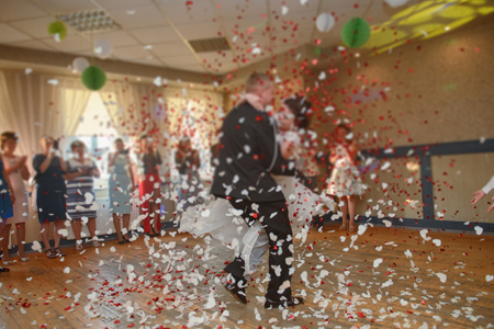 Bride and groom dancing the first dance at their wedding day. Guest on the dancefloor