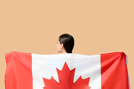 Young woman with national flag of Canada on color background