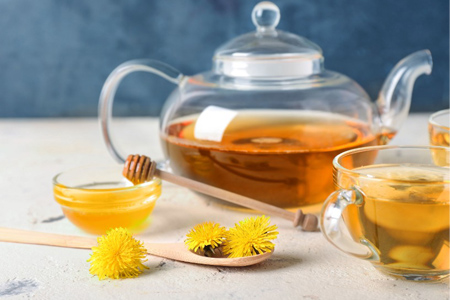 Healthy dandelion tea with honey on table