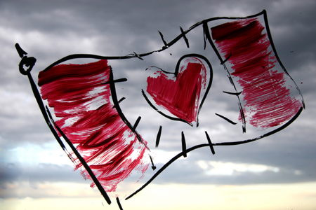 canada flag illustration over cloudy sky - maple leaf replaced with red heart