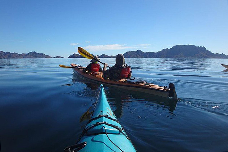 picture of two kayakers taken by author on kayak, mounains in background, taken in in Jasper Nationa