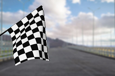 Checkered waving flag on city background. 