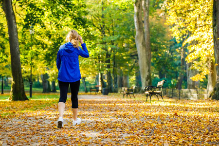 Middle-aged woman walking in city park