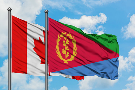 flags of Eritrea and Canada flying side by side